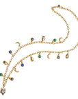 Gold long chain featuring crescent moon, fox, scarab, malachite, onyx, and lapis charms