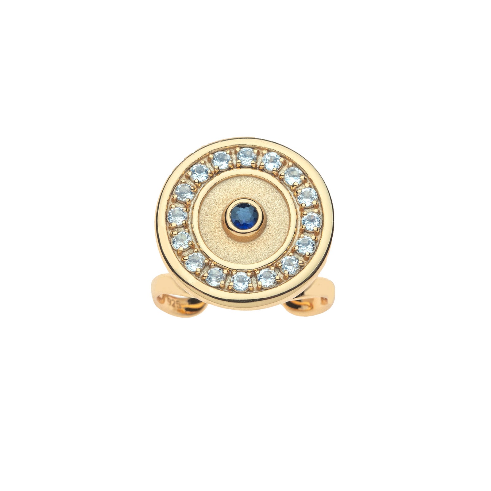 Gold ring features round evil eye motif with blue sapphire in the center and border of white topaz stones