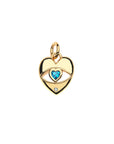 Gold heart pendant features cutout evil eye with London blue topaz heart in the center