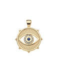 Gold coin pendant features cutout evil eye design. Center of evil eye features lapis stone with border of white topaz stones