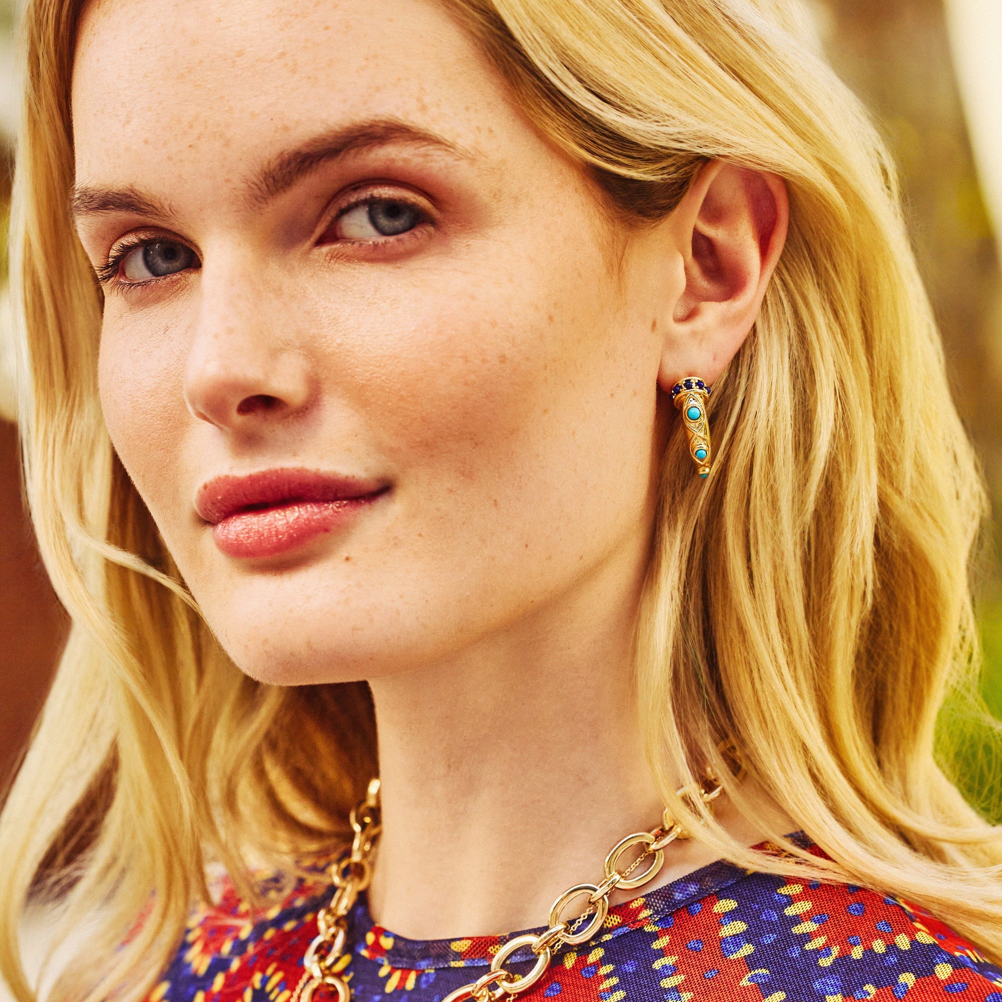 Model wearing the protect ancient eye tusk hoops.