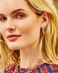 Model wearing the protect ancient eye tusk hoops.
