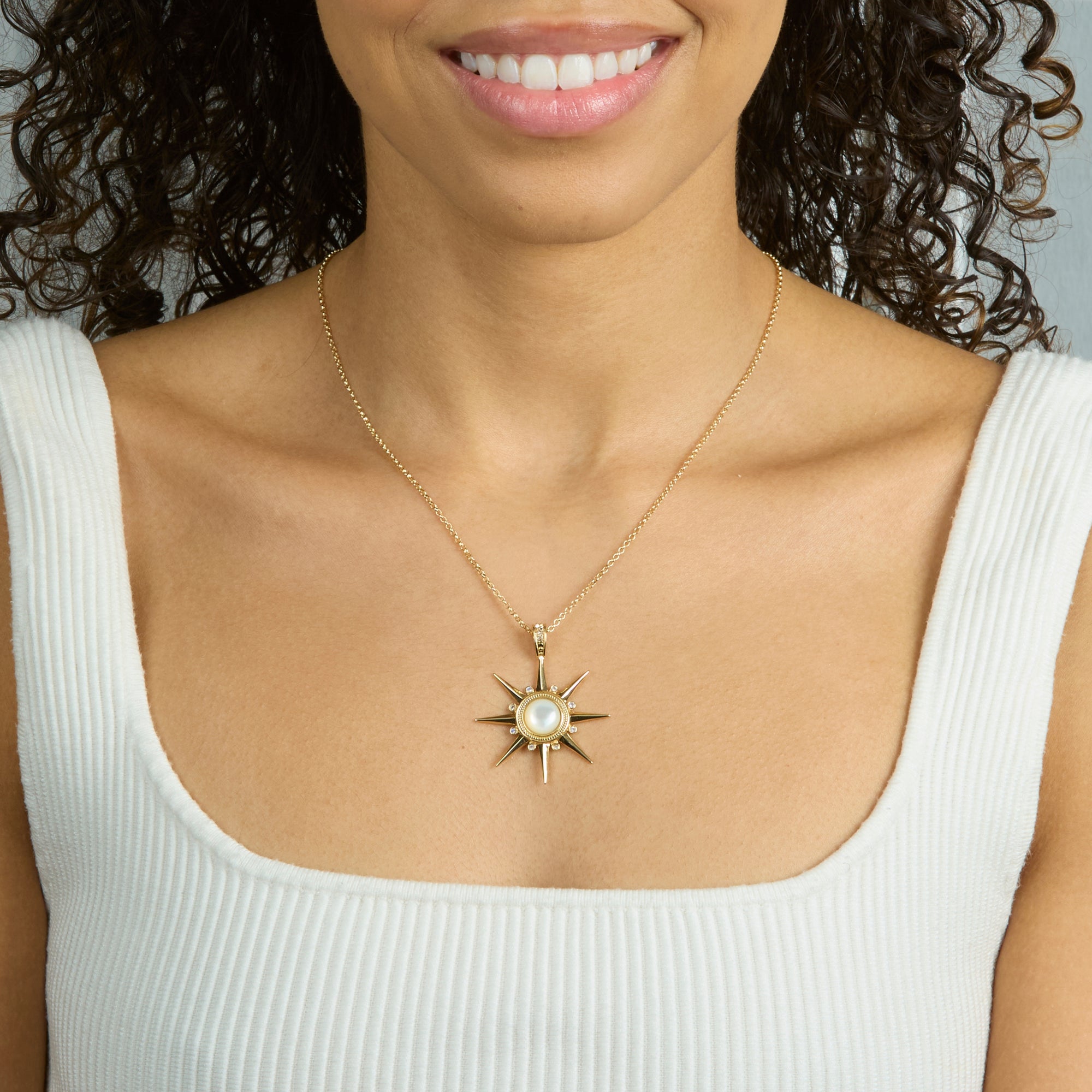 Model wearing the strong supernova pendant on the classic rolo chain