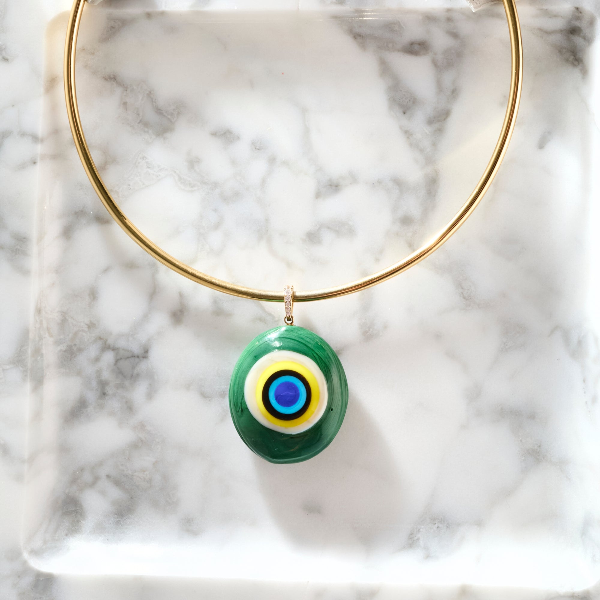 Protect glass eye pendant on the gold neck cuff