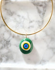 Protect glass eye pendant on the gold neck cuff