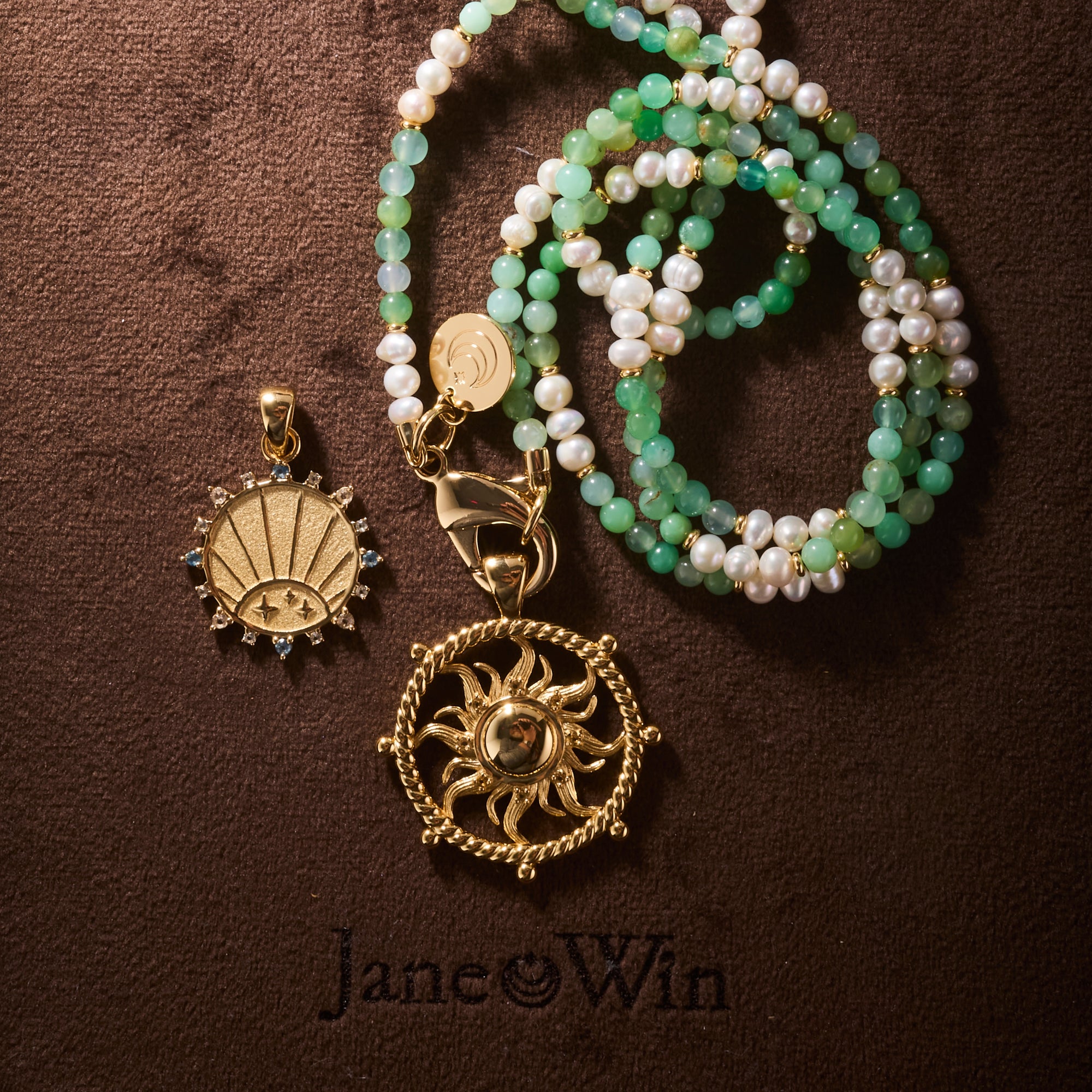 Stylized shot of chrysoprase & pearl double wrap, strong flaring sun cutout coin, and strong petite embellished coin