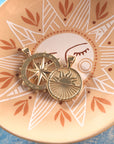 Stylized shot of the strong over the horizon coin and forever sundial cutout in dish featuring sun motif