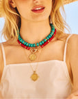 Model wearing the red coral gumdrop, strong stone collector in turquoise, and the protect eagle petite embellished