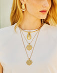 Model wearing the strong love of the sea coin, the strong along the shore pendant, and the strong along the short earrings