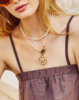Model wearing the strong light of the ocean charm on the pearl double wrap