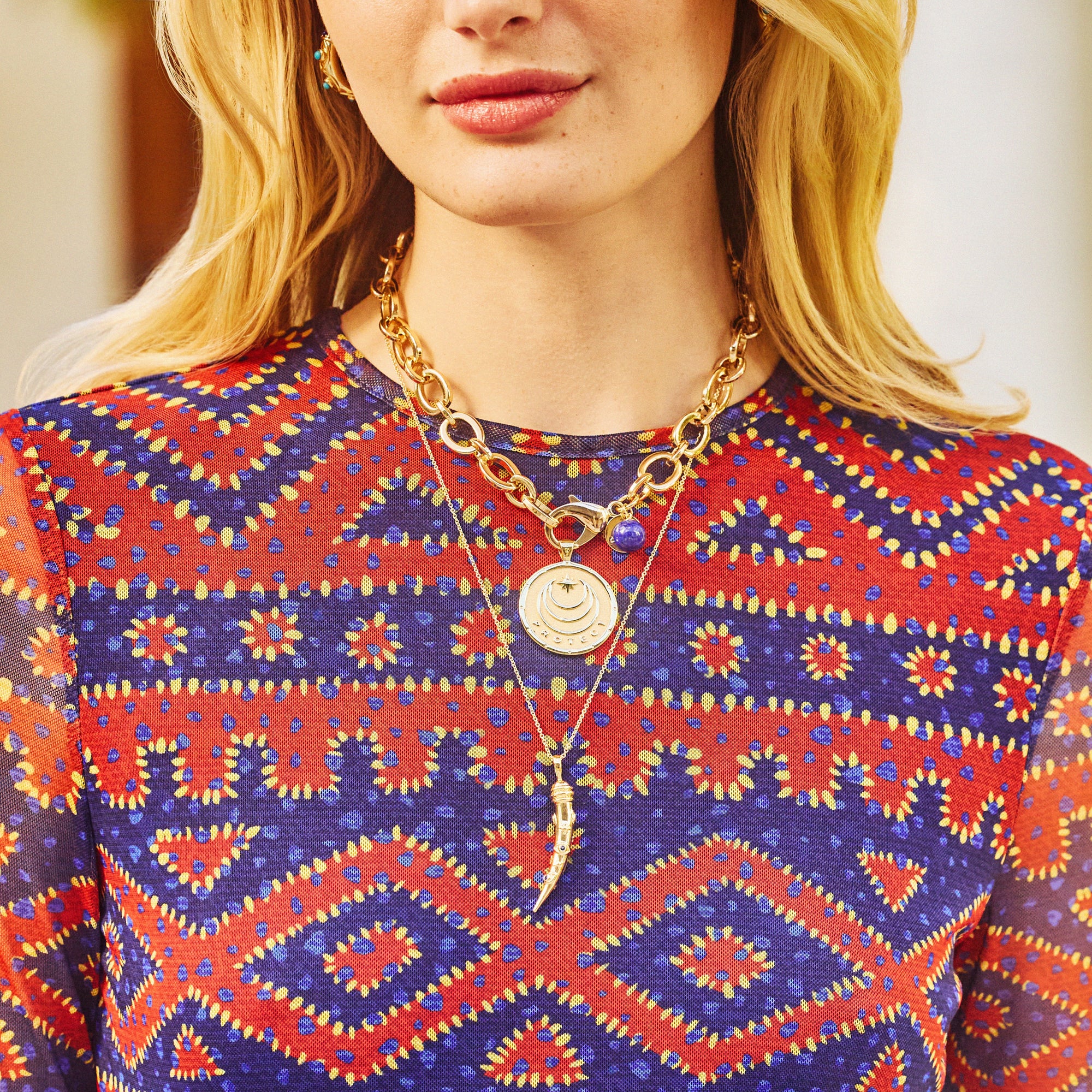 Model wearing the protect ancient eye tusk, as well as the protect original coin on the chunky chain.