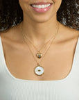 Model wearing the protect eye of stone on the classic rolo chain layered with the protect hold my heart pendant on the classic rolo