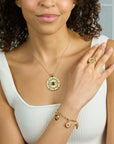 Model wearing the protect gleaming eye pendant on the classic rolo chain, protect evil eye charm bracelet, and protect eye on you ring