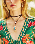 Model wearing the strong in the shallows shell pendant on the leather lariat