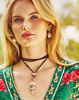 Model wearing the leather lariat with the strong in the shallows shell pendant, as well as the strong soaking up the sun earrings