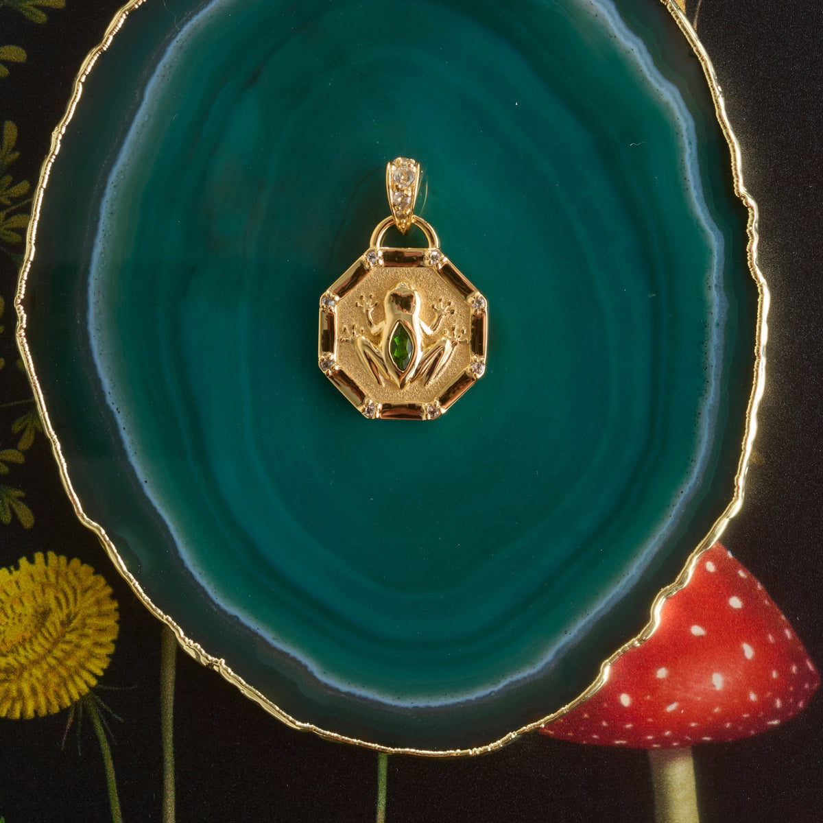 Stylized shot of the lucky frog petite embellished on a green agate slice