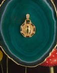 Stylized shot of the lucky frog petite embellished on a green agate slice