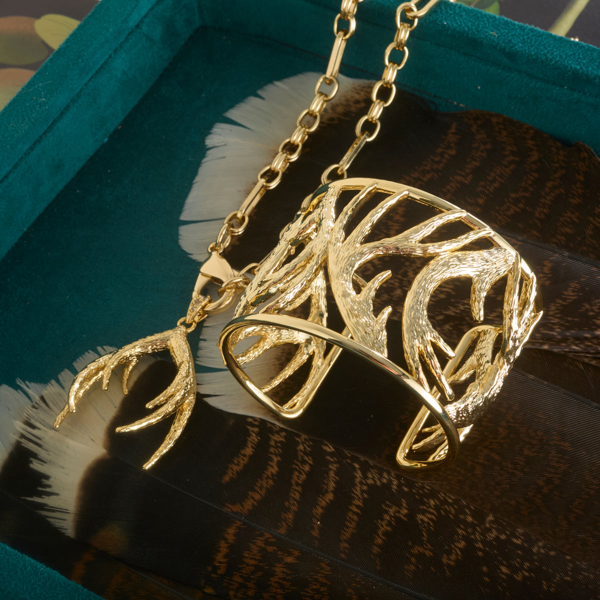 Stylized shot of the protect guardian antler pendant on the across all time chain, as well as the protect guardian antler cuff