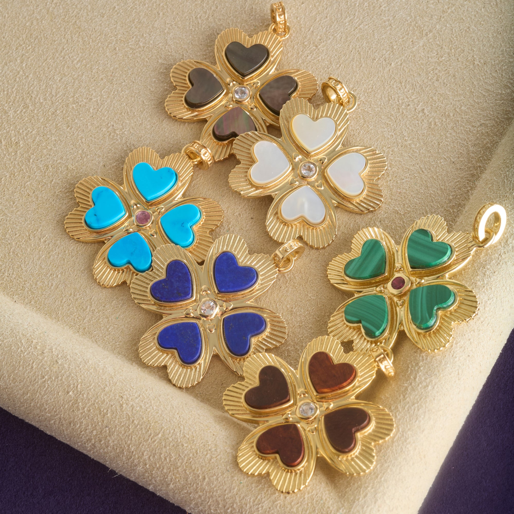 Stylized shot of six different colors of the lucky in love clover pendant