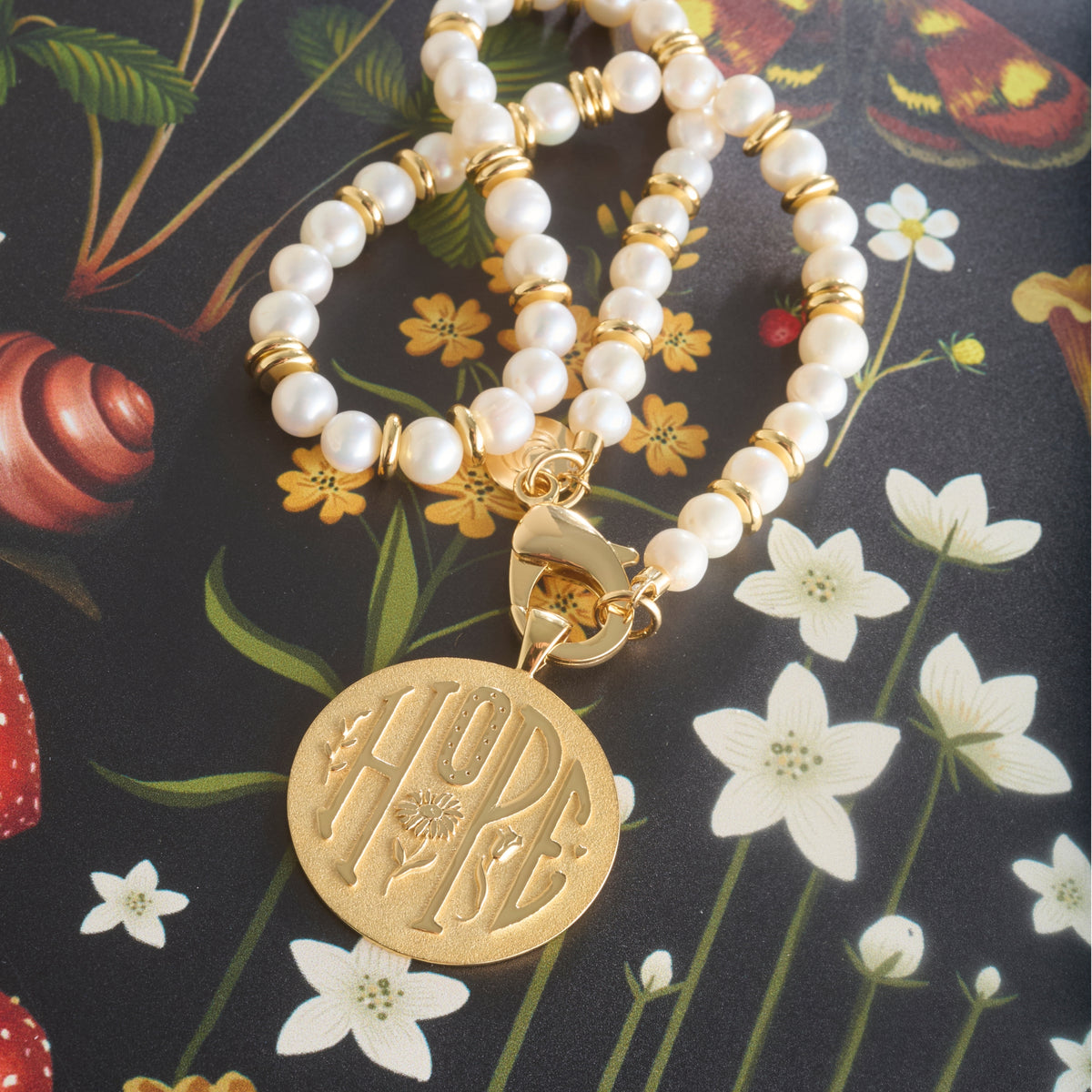 Stylized shot of the jumbo hope coin on the calypso pearl necklace