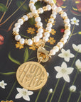 Stylized shot of the jumbo hope coin on the calypso pearl necklace