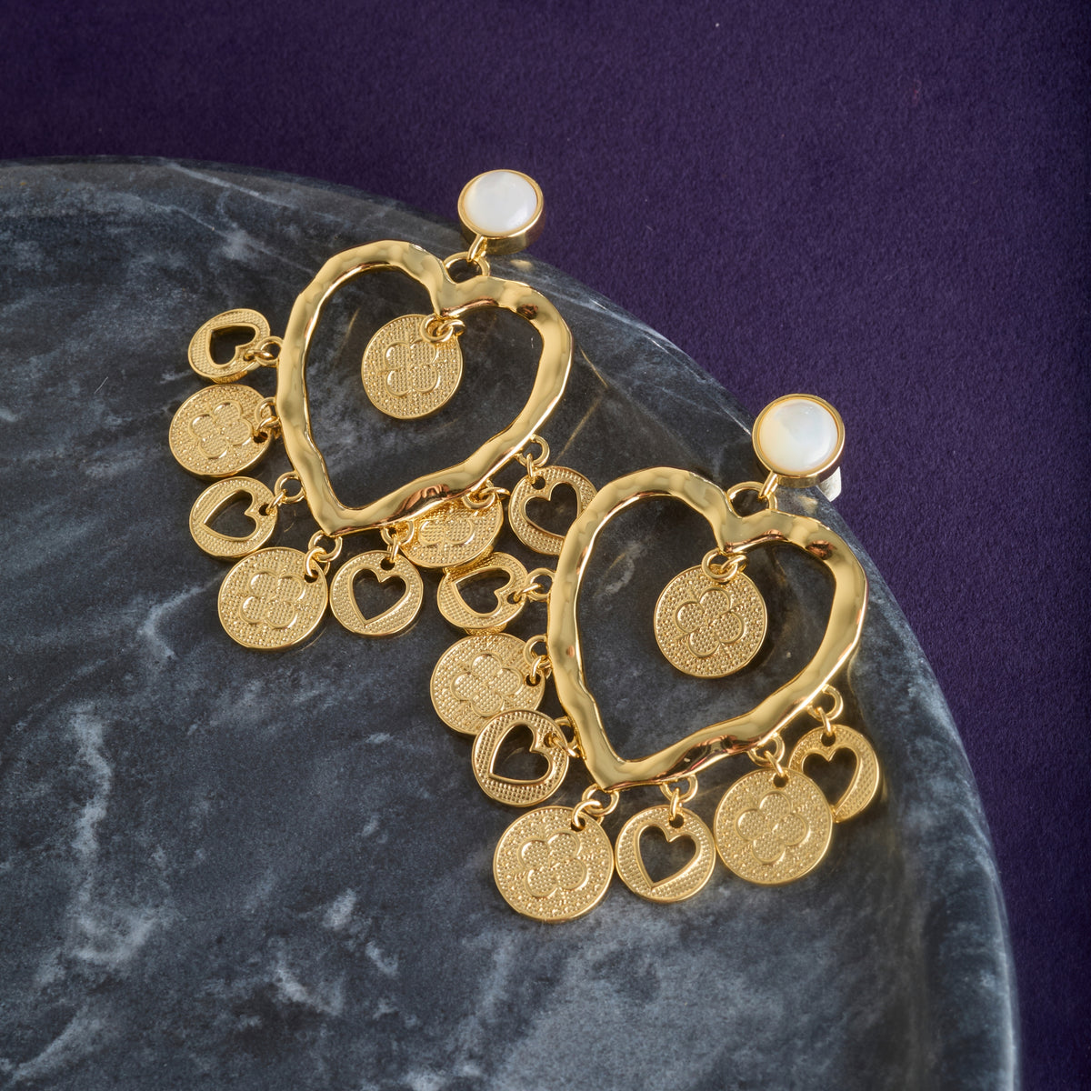 Stylized shot of the love amore coin earrings