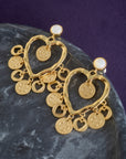 Stylized shot of the love amore coin earrings