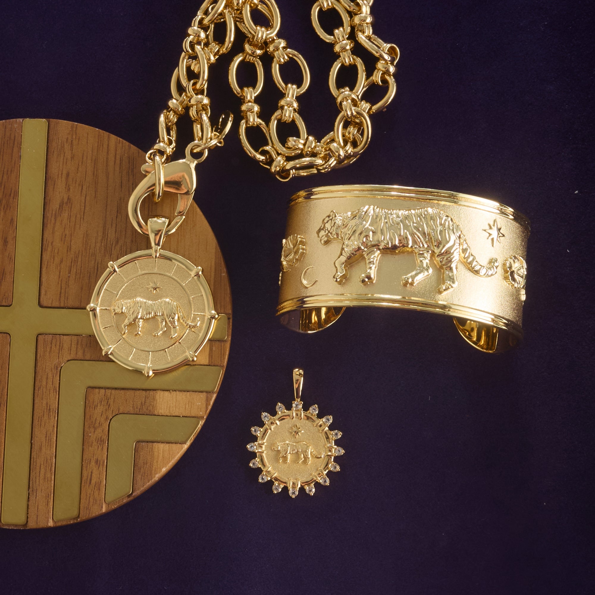 Stylized shot of tiger coins and tiger cuff with greenville chain necklace