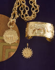 Stylized shot of tiger coins and tiger cuff with greenville chain necklace