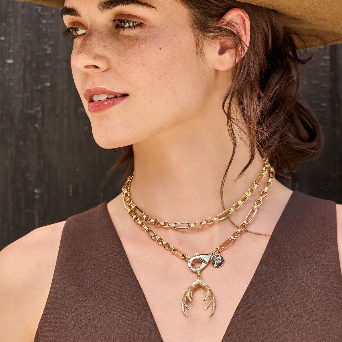 Model wearing the across all time double wrapped chain with the protect guardian antler pendant