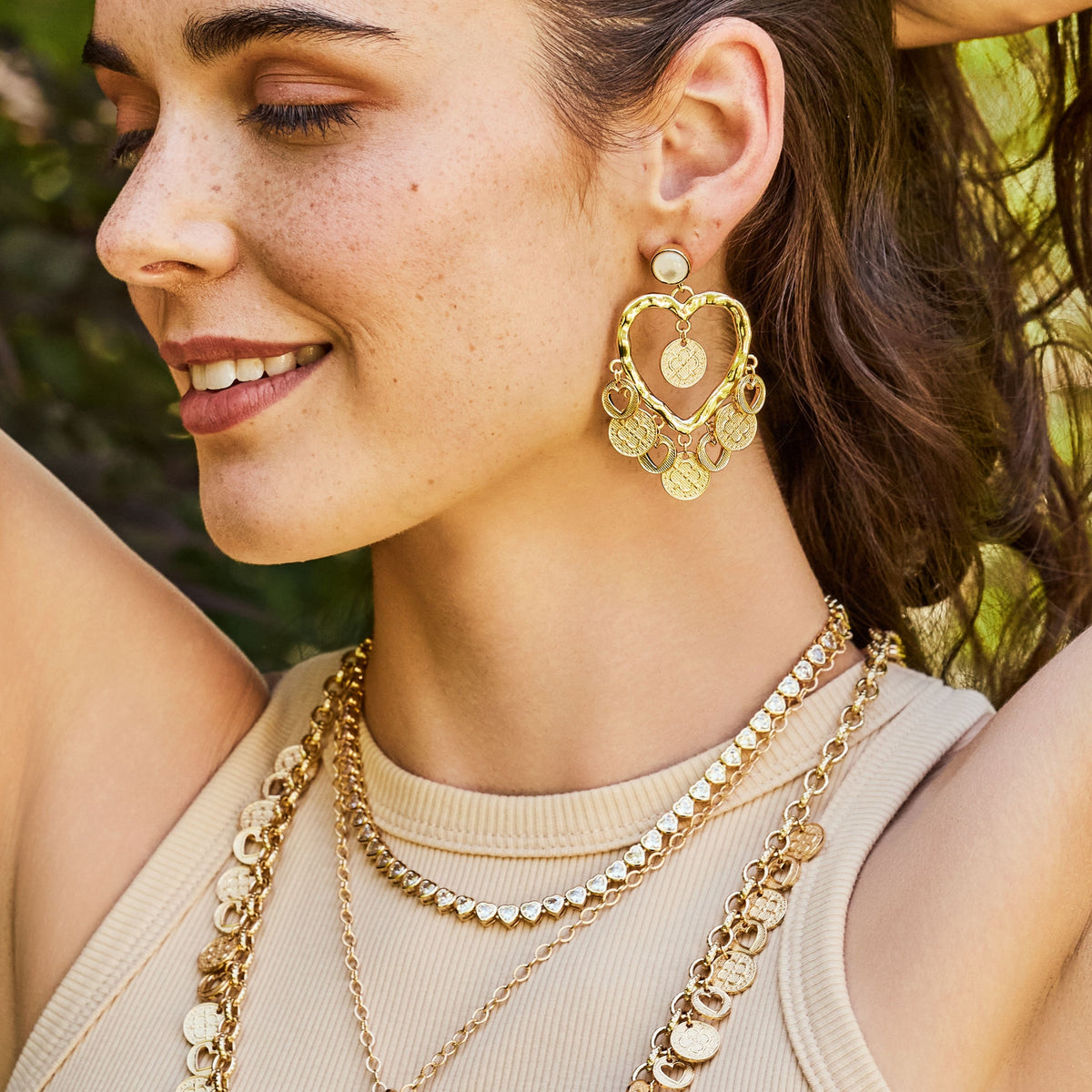 Model wearing the love amore coin drop earrings 