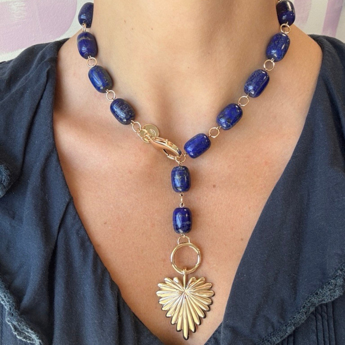 Model wearing the chunky lapis lariat with the full heart pendant