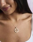 Model wearing the love cutout coin pendant on a delicate chain