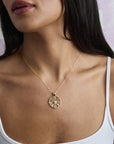Model wearing the forever cutout coin pendant on delicate chain