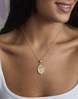 Model wearing the faith shield pendant on the classic rolo chain