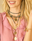 Model wearing various engravable pendants and chains