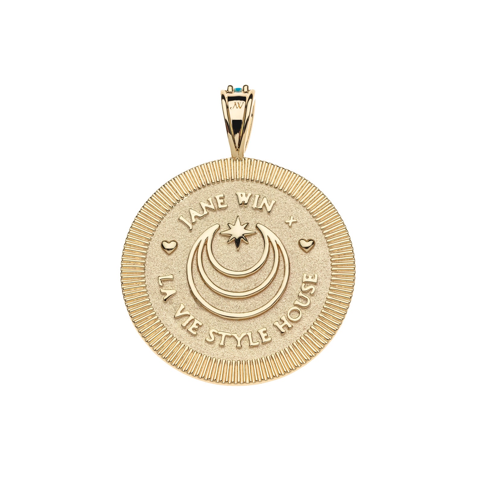 Back of gold coin pendant features moon and star logo, heart details, and "JANE WIN X LA VIE STYLE HOUSE"