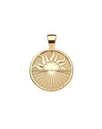 Gold coin pendant features rising sun over the horizon