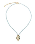 Rainbow moonstone beaded necklace featuring gold cowrie shell pendant with turquoise cabochon accent