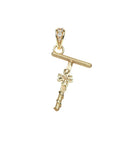 Gold letter T pendant with flower detail and white topaz accents on the bail