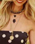 Model wearing assorted fox pendants and layered chains
