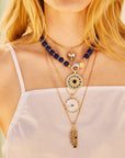 Model wearing various evil eye pendants