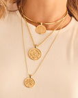 Gold necklaces layered on model