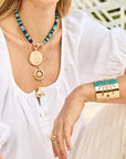 Model wearing various pendants and strong supernova cuff