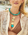 Model wearing assorted necklaces and pendants