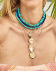 Model wearing assorted beaded necklaces and pendants