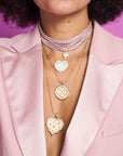 Gold layered necklaces on model