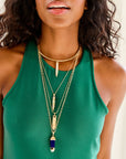 Model wearing various sun ray pendants