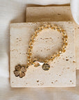 Gold chunky rolo chain bracelet with dogwood charm