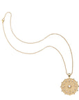 Gold wanderlust coin pendant on classic rolo chain